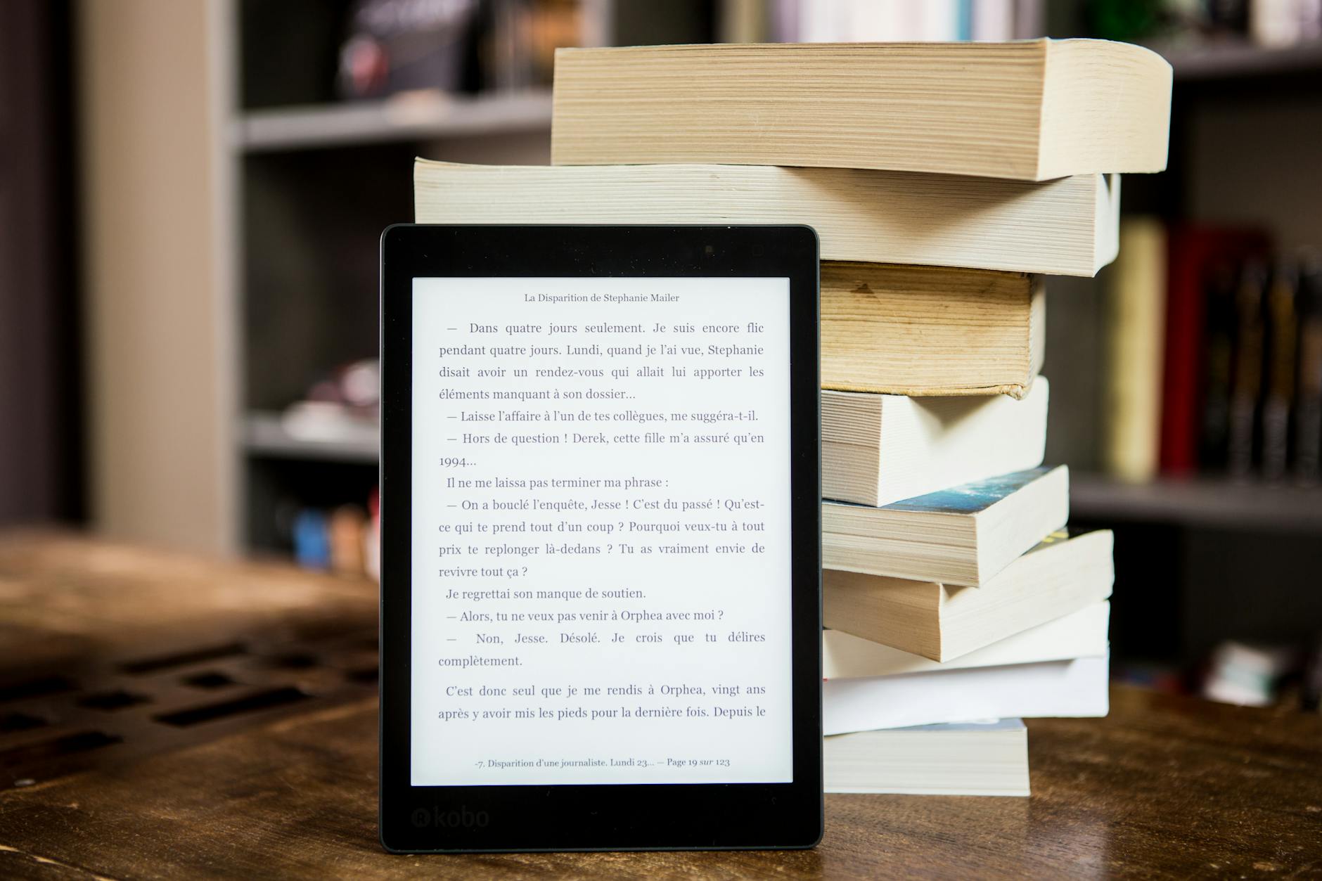 black tablet computer behind books